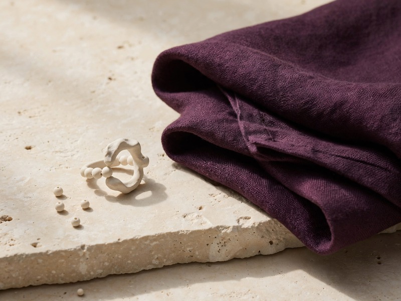 A ceramic ring beside linen
